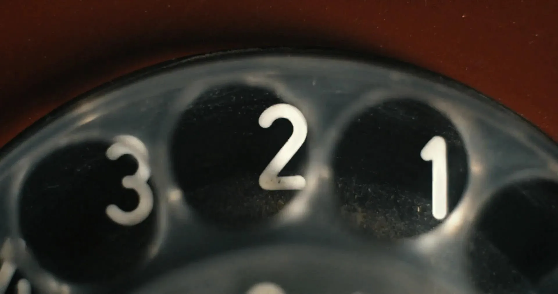 Still from Anthropic's Claude Sonnet 5.5 announcement video: a close-up of a rotary telephone dial showing the numbers 3, 2 and 1